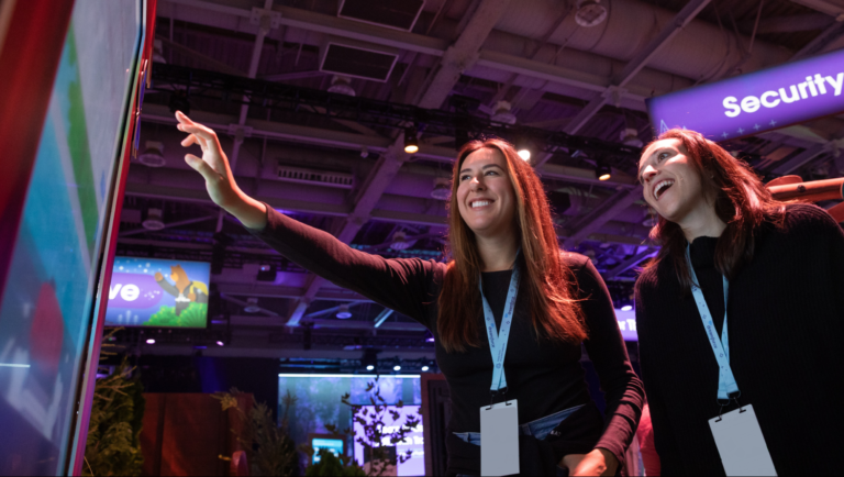 Two people playing security games at Dreamforce booth