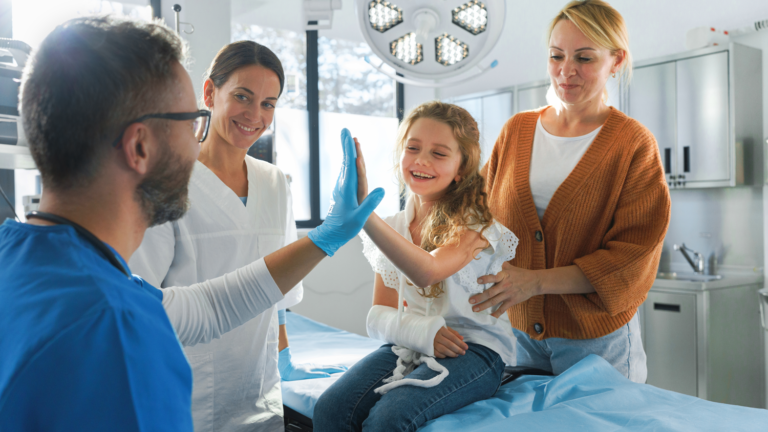 Image shows a mother and child speaking to a doctor.