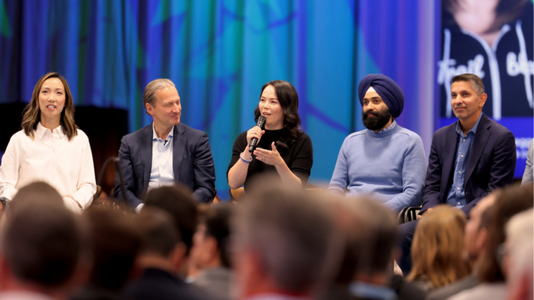 Clara Shih, David Schmaier, Kat Holmes holding a mic and talking, Khushwant Singh, and Param Kahlon. Leaders on stage during True to the Core at Dreamforce 2024.