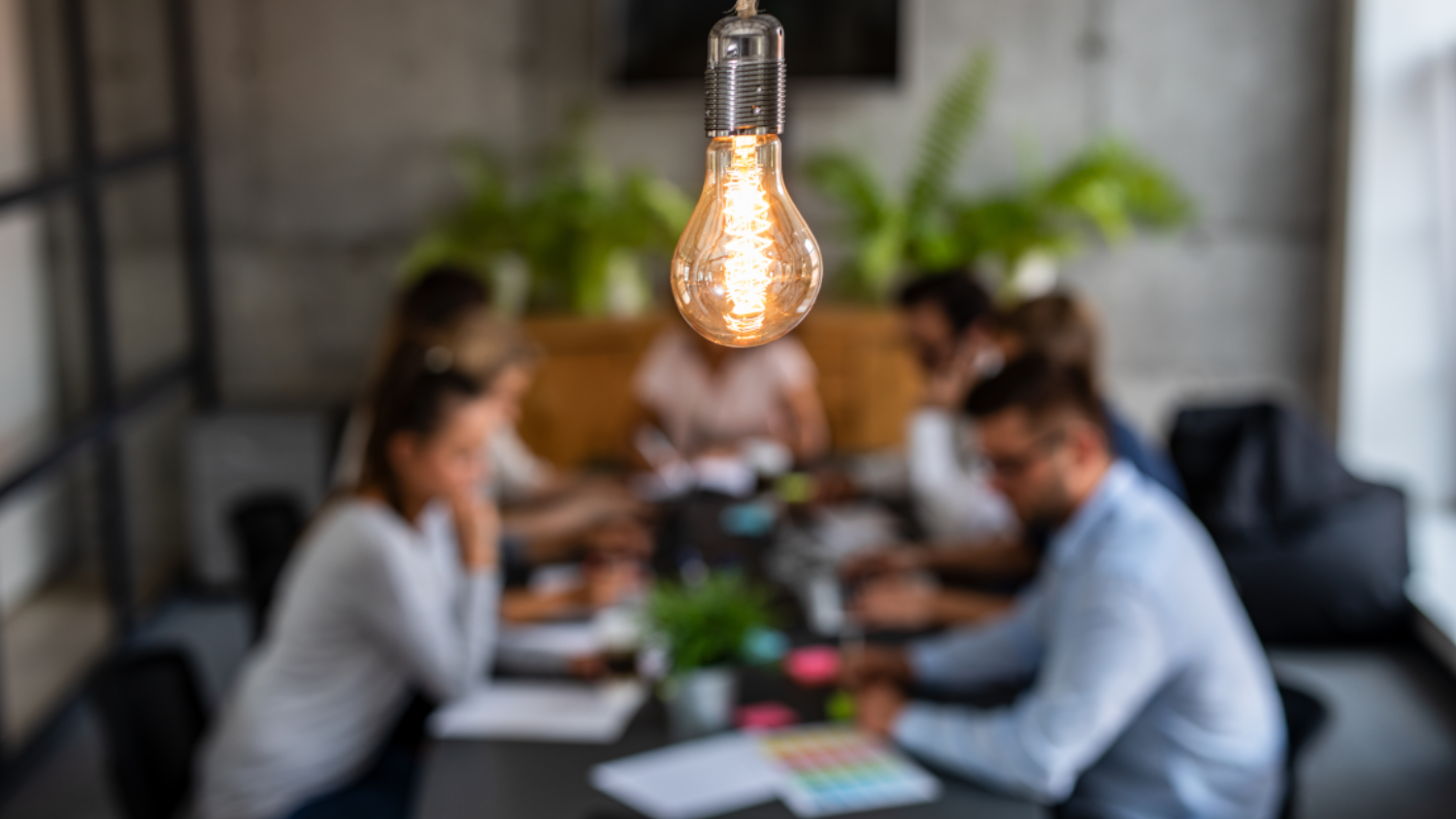 A group of people ideating around a table.