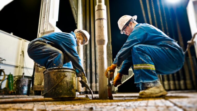 Two oil and gas workers on the job.